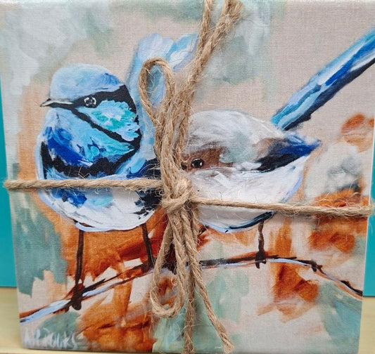 Decorative tile with animal design tied with twine against a teal background