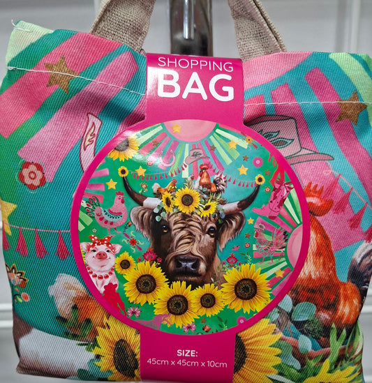 Colorful shopping bag with a dog and sunflower design on a metal surface.
