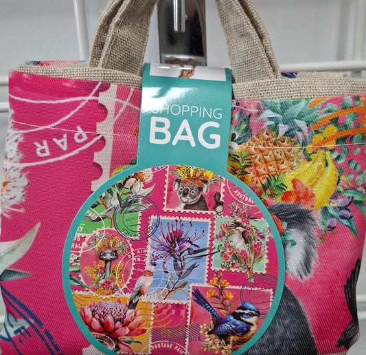 Floral and patchwork patterned bag with a tag on a metal surface