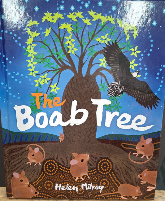 Children's book titled 'The Boob Tree' with animal illustrations on a wooden surface.