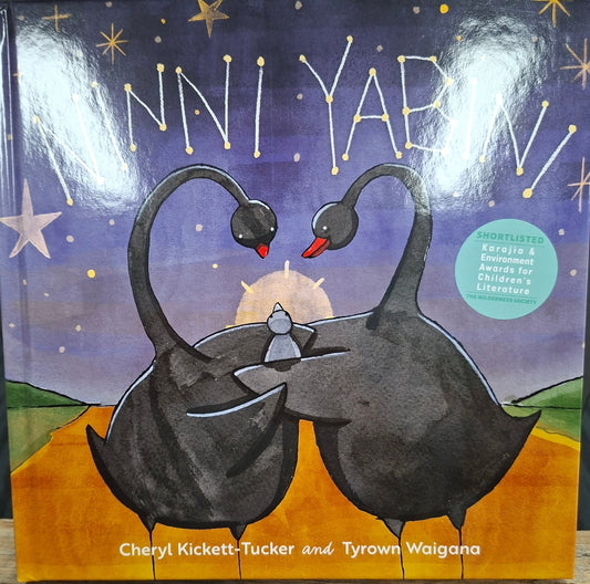 Book cover with two cats under a moonlit sky on a wooden surface