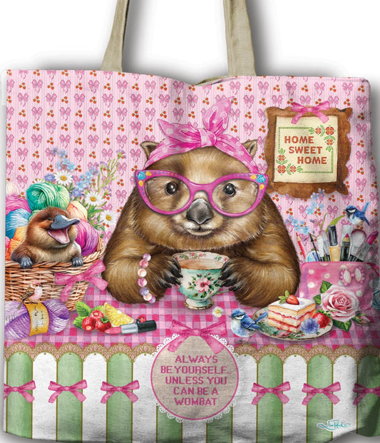 Tote bag with a bear design and text, held by a hand against a white background.