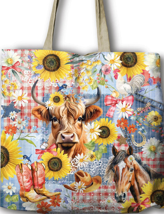 Tote bag with cow and sunflower design held by a hand against a white background